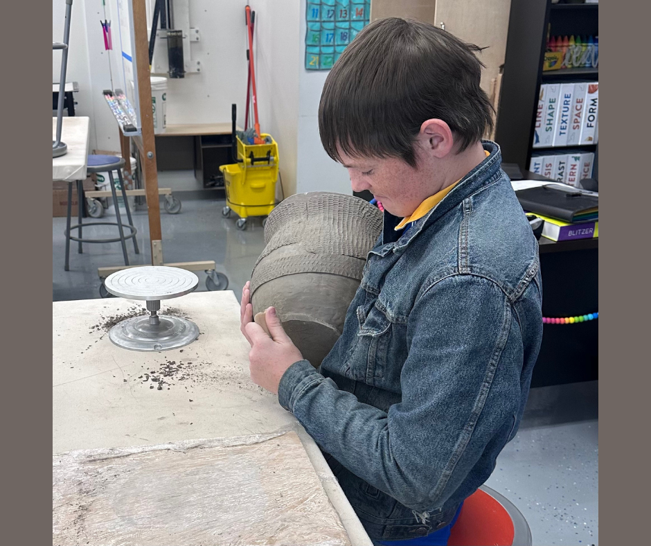 Wyatt working on his pottery.