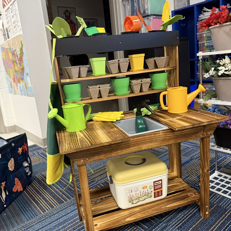 Potting bench but missing in this picture was small totes of black beans (soil) and split peas. These added elements allow students to explore capacity and needs of a flower or plant.