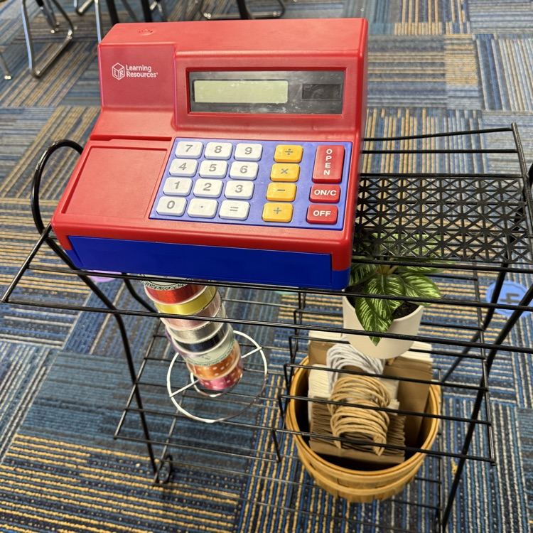 Cash register to help incorporate the idea of commerce and money exchange.