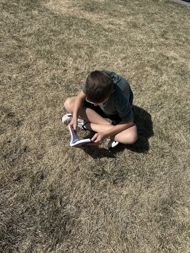 5th grade student reading outside