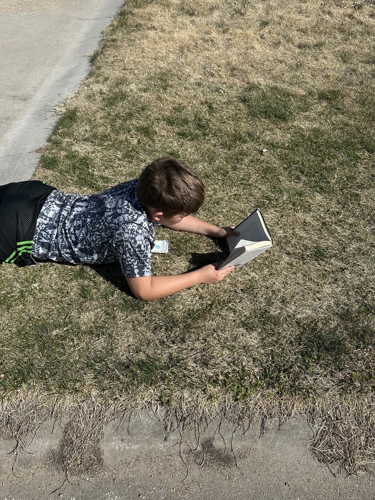 5th grade student reading outside