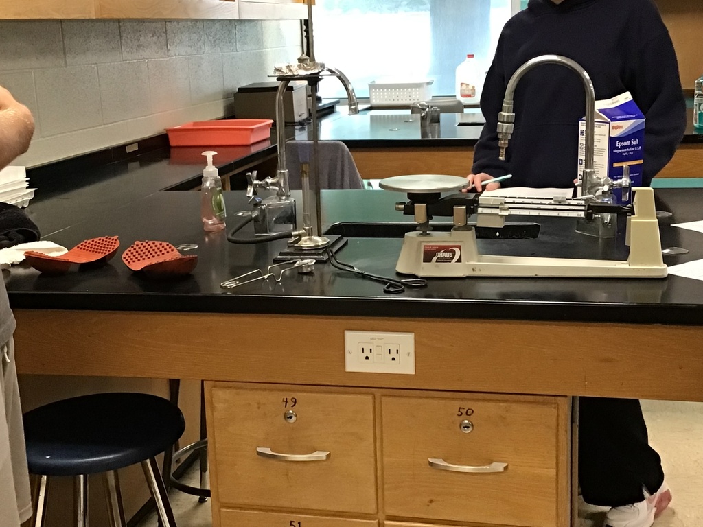 A sample on a lab station being heated above a bunsen burner