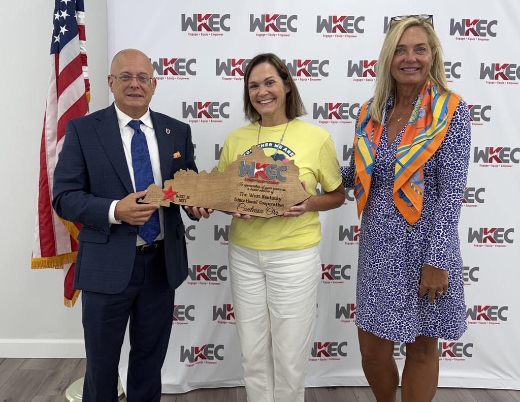 people standing with a plaque