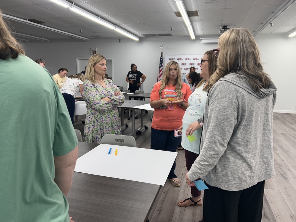 people standing in a room collaborating