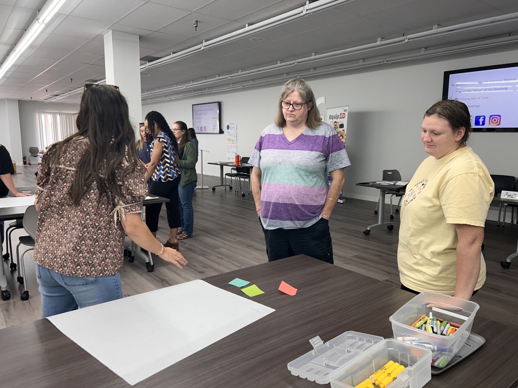 people standing in a room collaborating