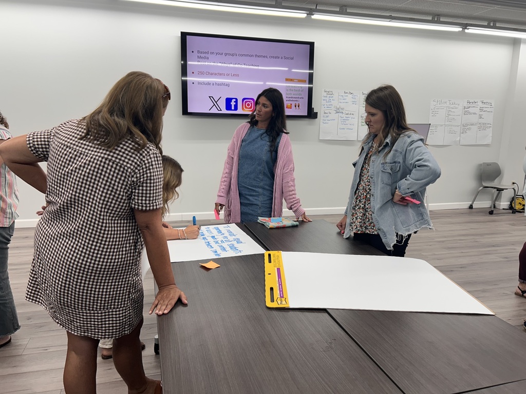 people standing in a room collaborating