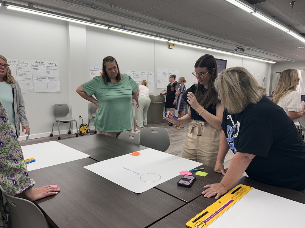 people standing in a room collaborating