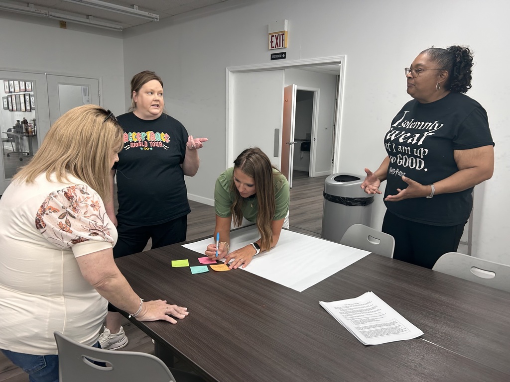 people standing in a room collaborating