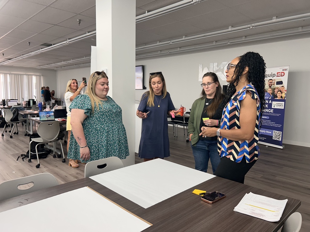 people standing in a room collaborating