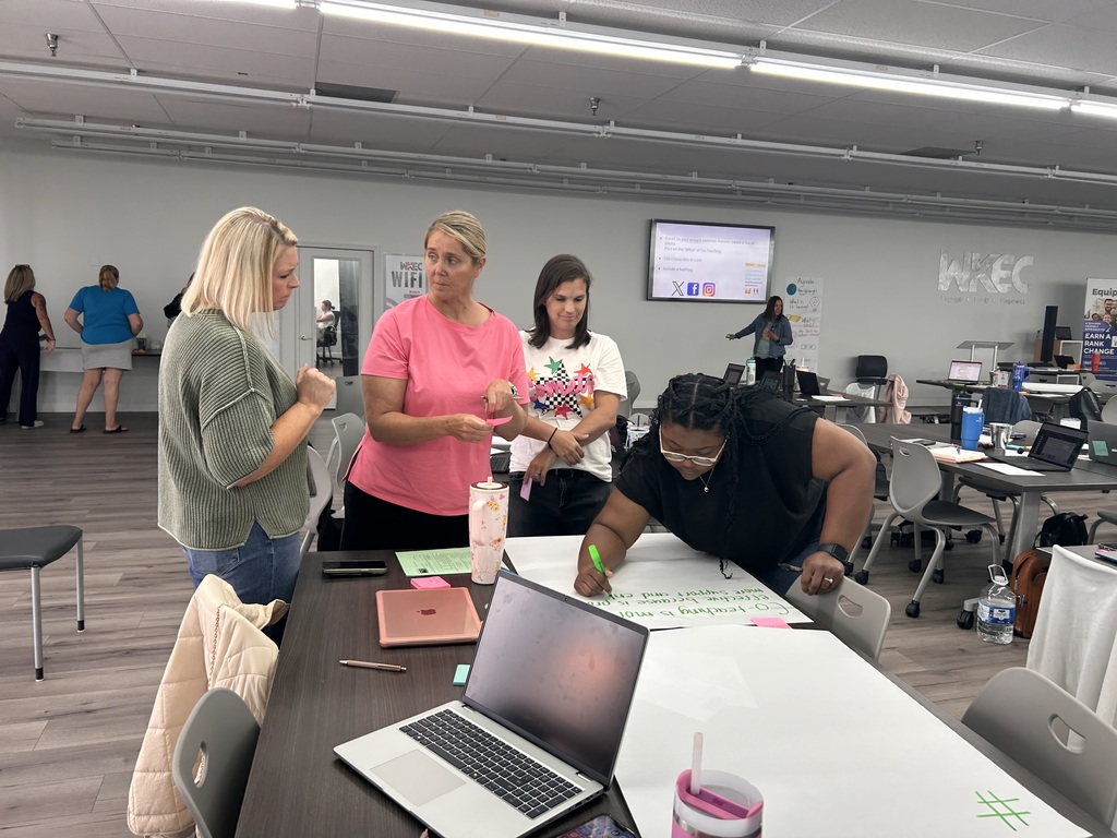 people standing in a room collaborating