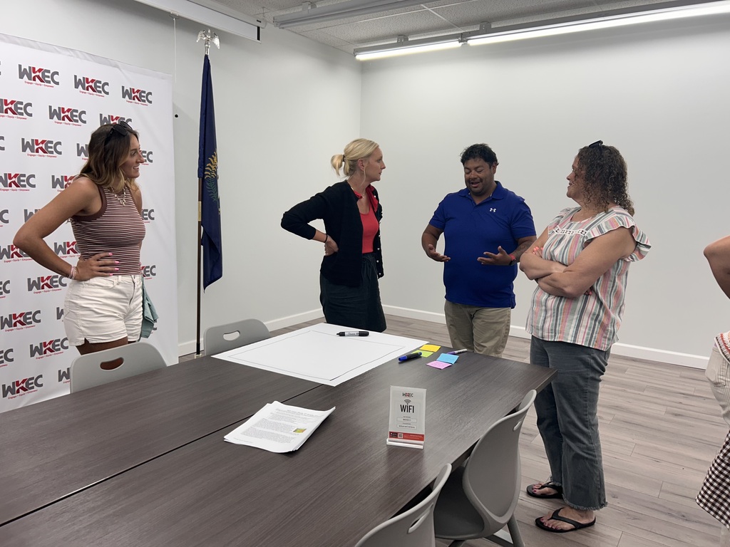 people standing in a room collaborating