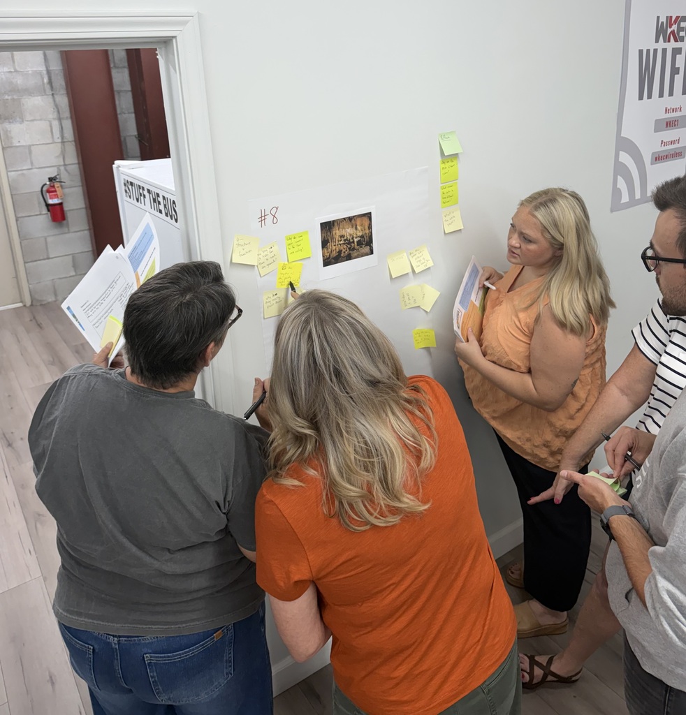 people standing in a room collaborating
