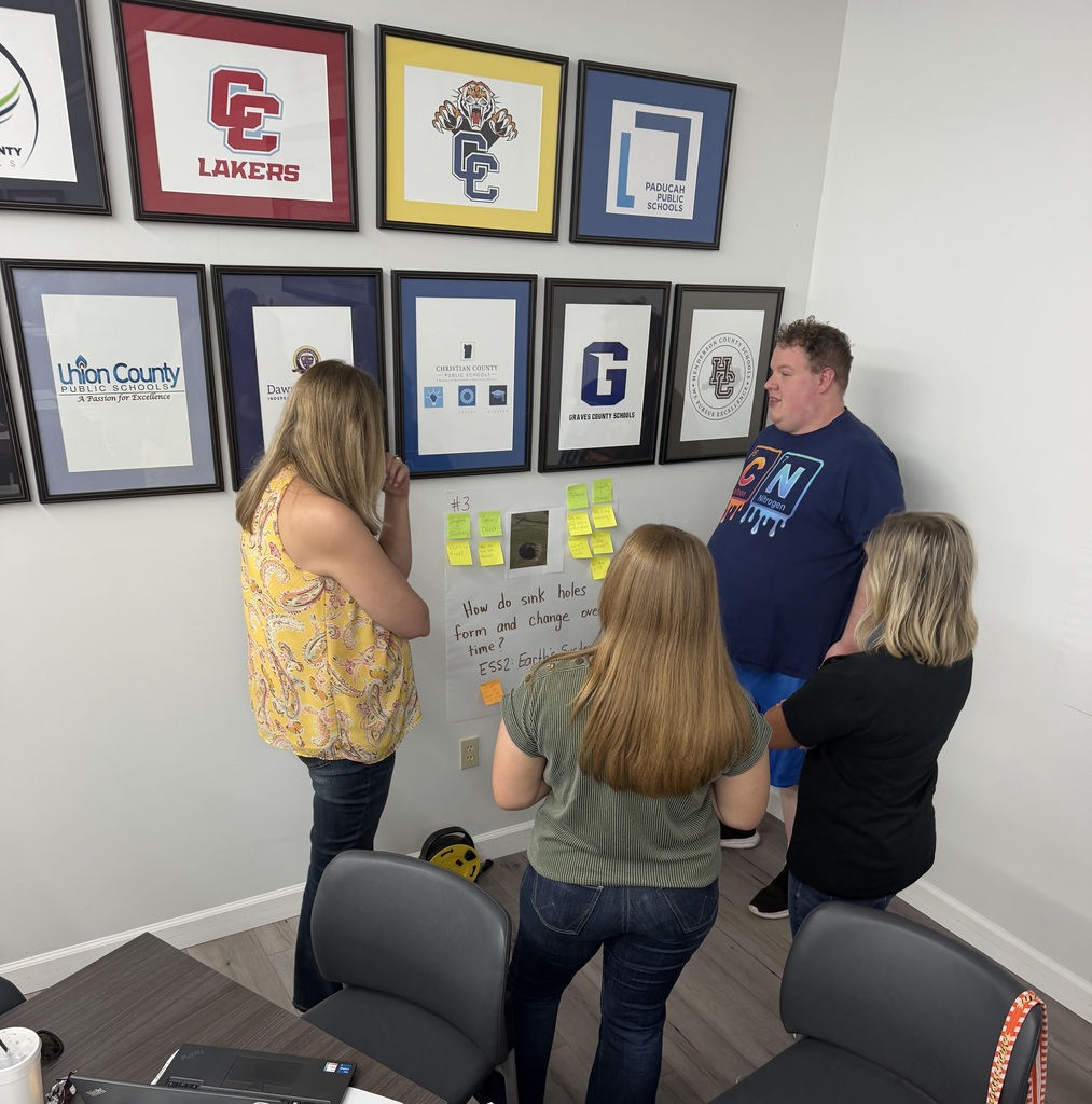 people standing in a room collaborating