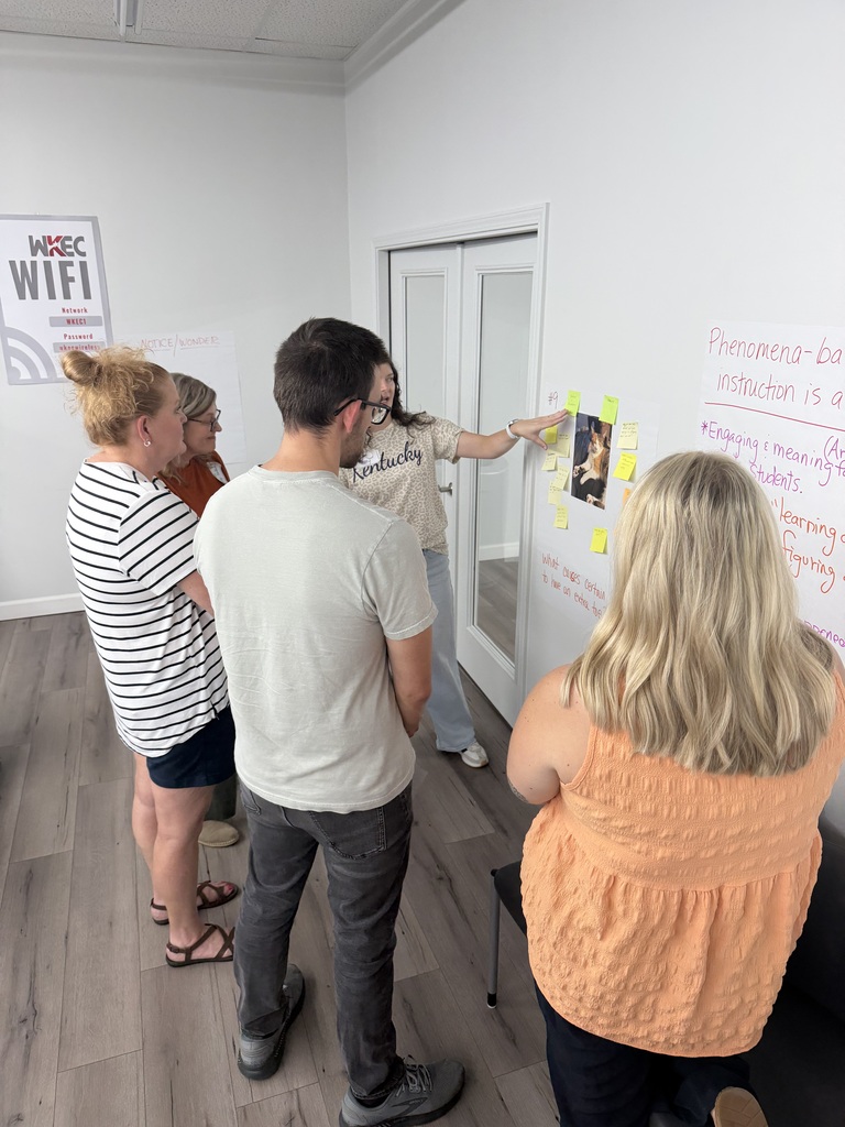 people standing in a room collaborating