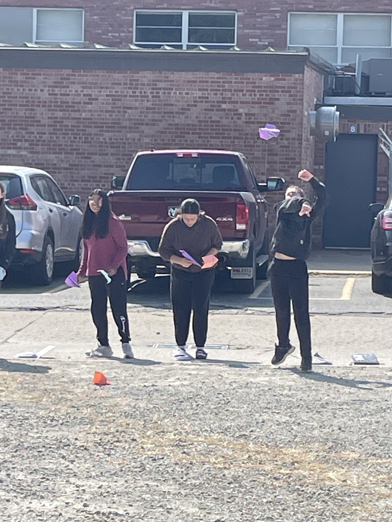 8th graders testing their paper airplane designs in science!