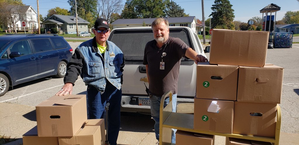 West Liberty Foods driver Shooter and West Liberty Middle School Custodian, Scott Peters unloading Backpack Program Food in 2020