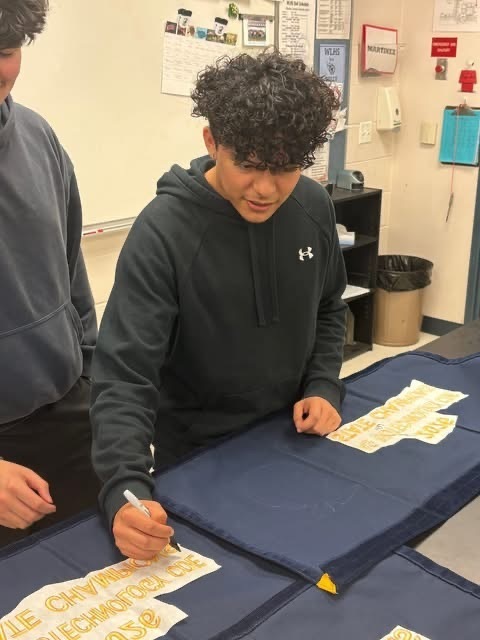 Signing the 2026 Ag Biotechnology State Champion Banner