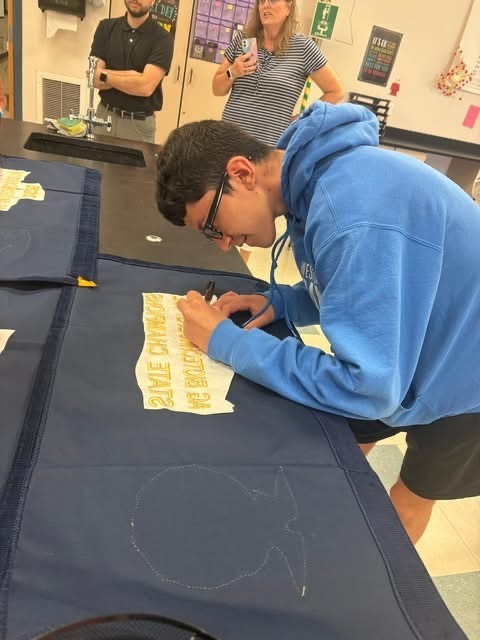 Signing the 2026 Ag Biotechnology State Champion Banner