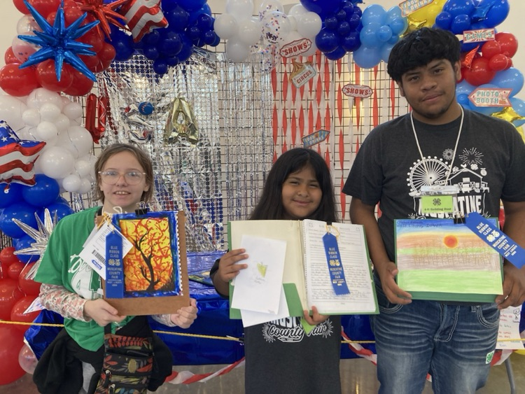 Zylah Spitznogle, Dana Avila Guerrero, and Esteban Estrada Martinez with their projects and blue ribbons