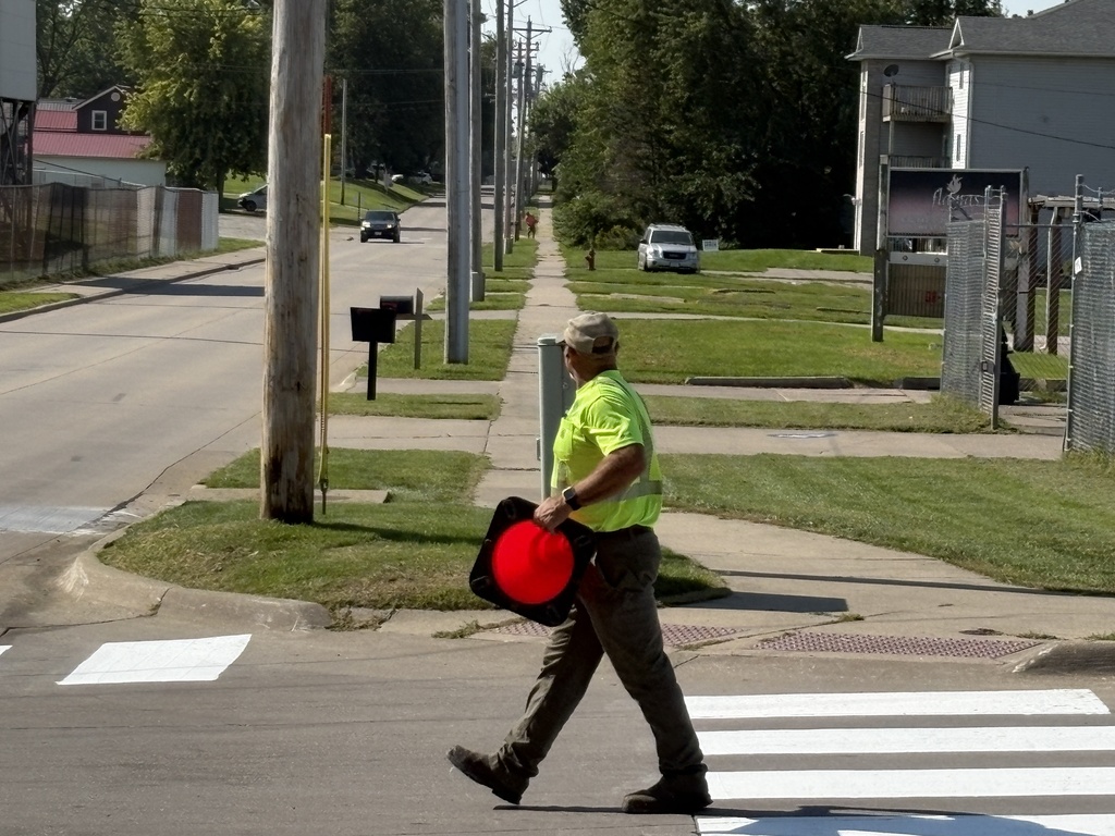 City of West Liberty workers painting crosswalks near WLHS