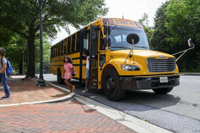 students deborading bus