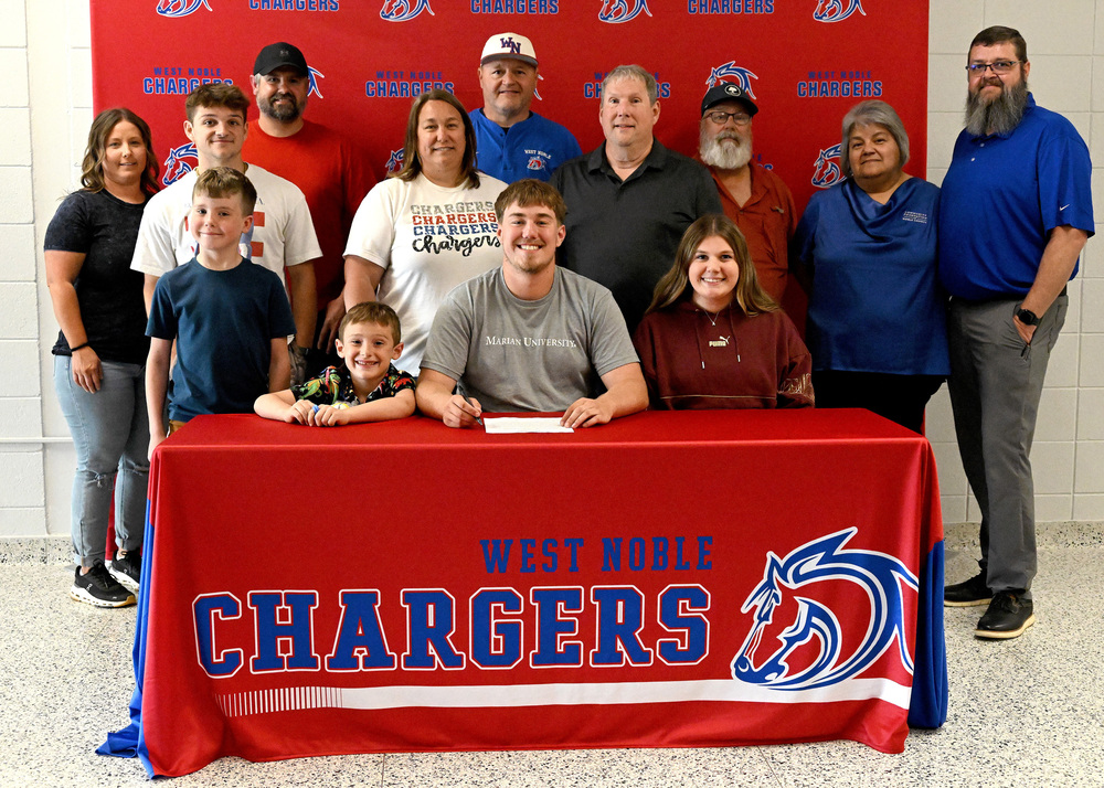 over a dozen people at a college signing