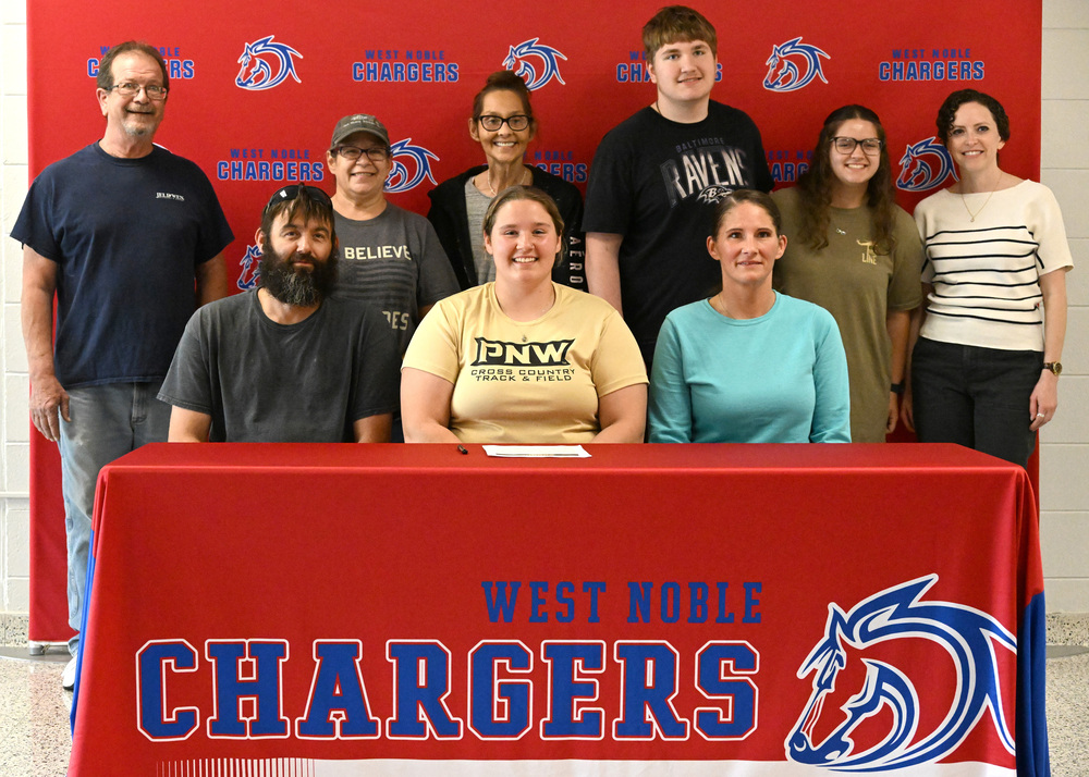 nine people at a college signing