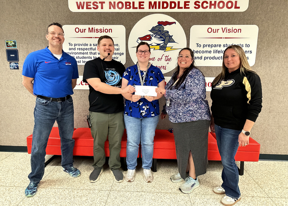 Amy Church donating money to West Noble band