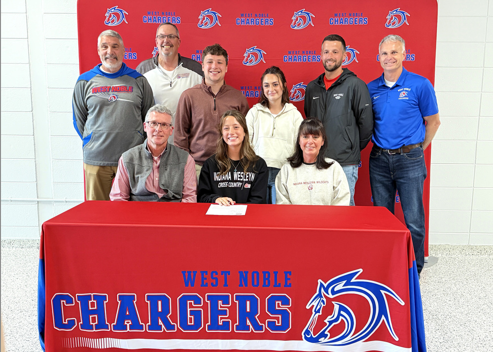 trinity parson with family and friends at a signing day event