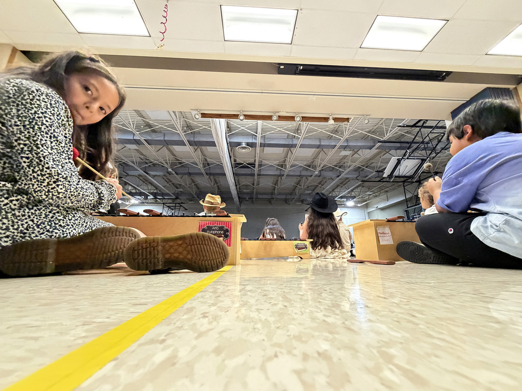 kids playing instruments at the music program