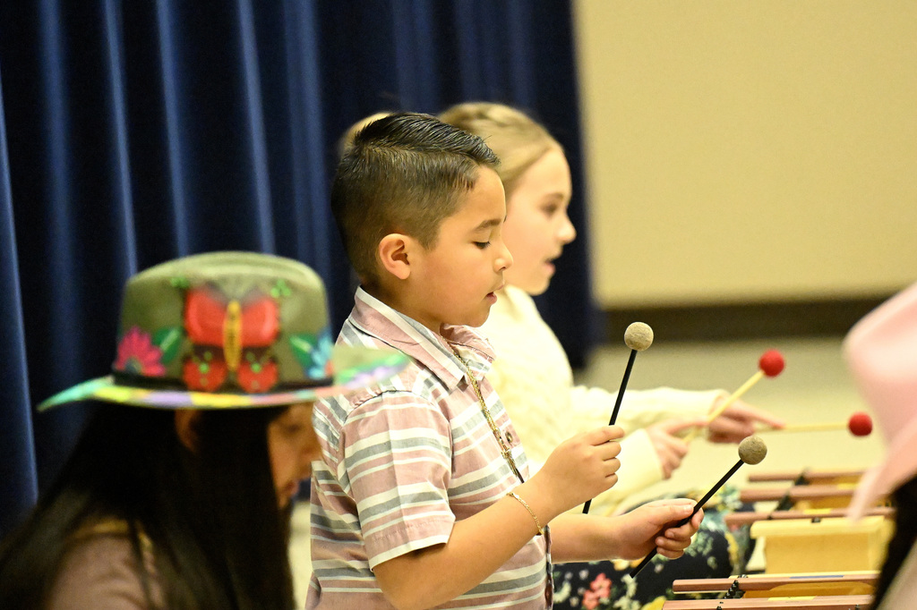 kids playing instruments at the music program