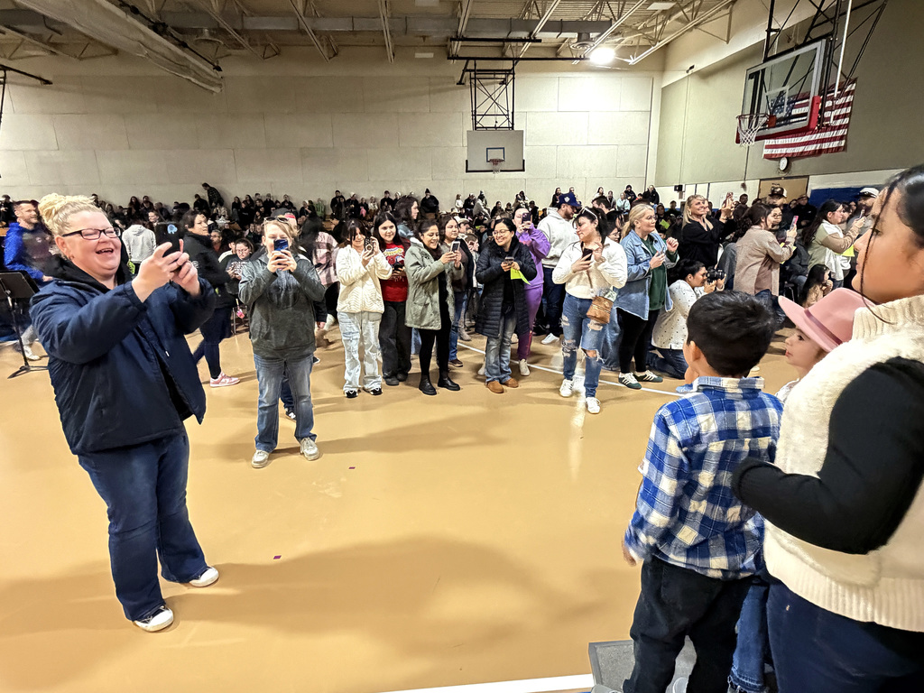 parents taking pictures of kids at the concert