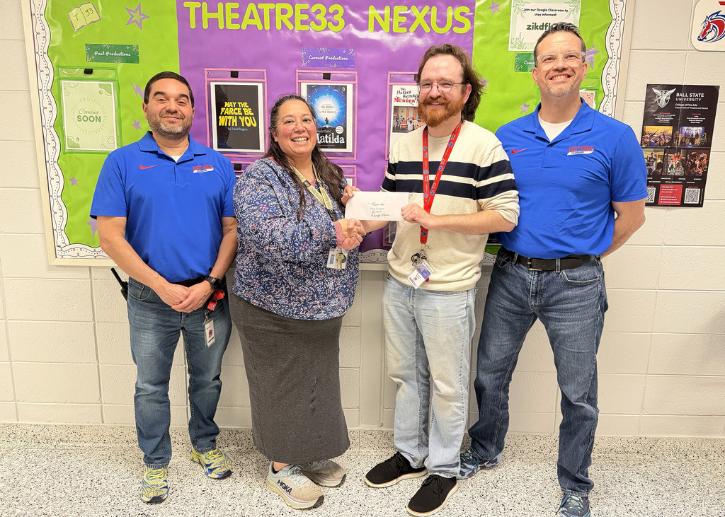 amy church presenting a donation to Theatre33 with three other individuals