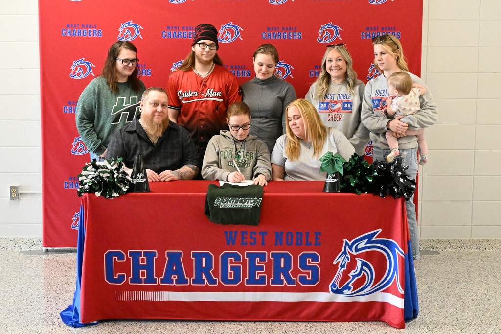 bella barnes at her college signing with family