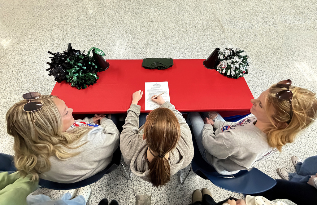 bella barnes signing papers at her college signing