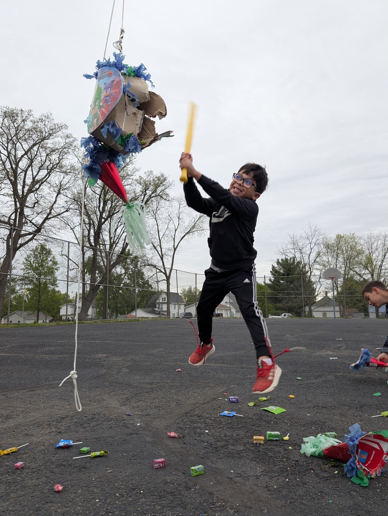 a young boy hitting a pinata