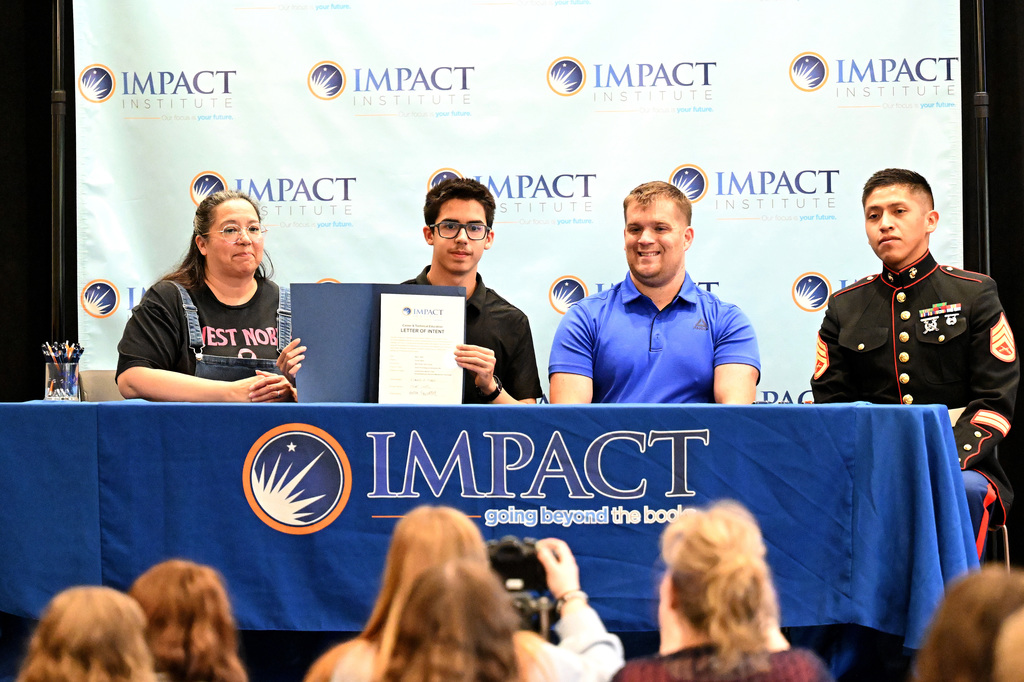 four people at a signing day event