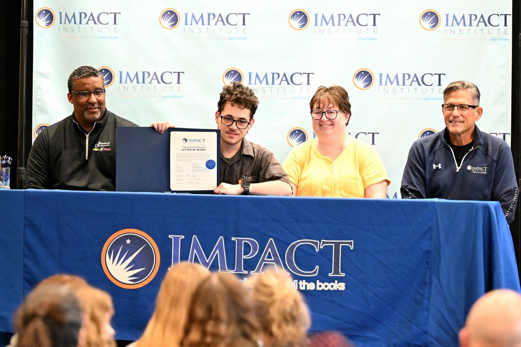 four people at a signing day event