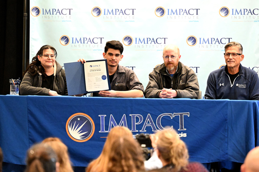 four people at a signing day event