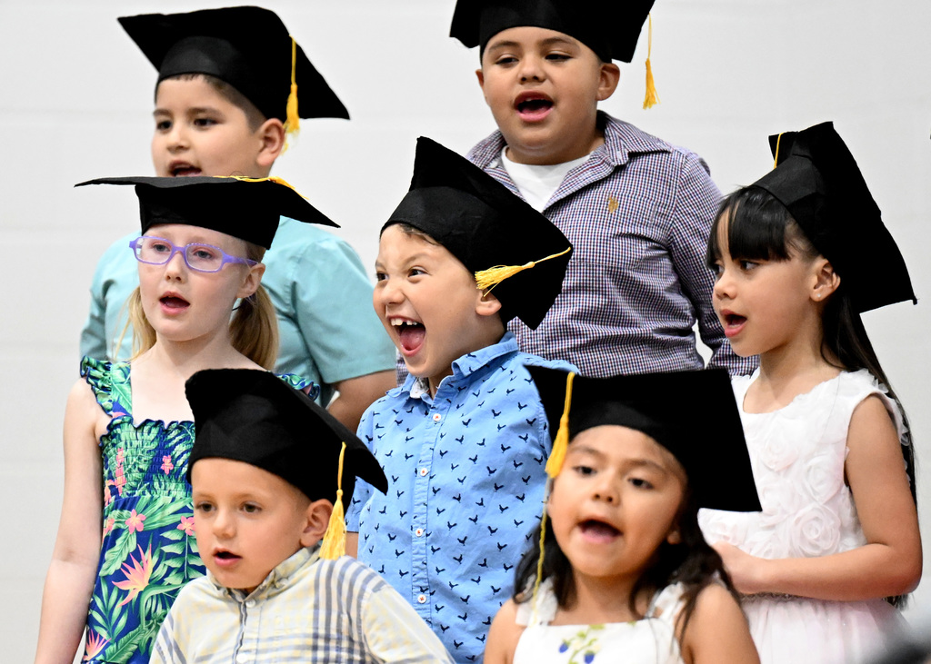 students singing at graduation