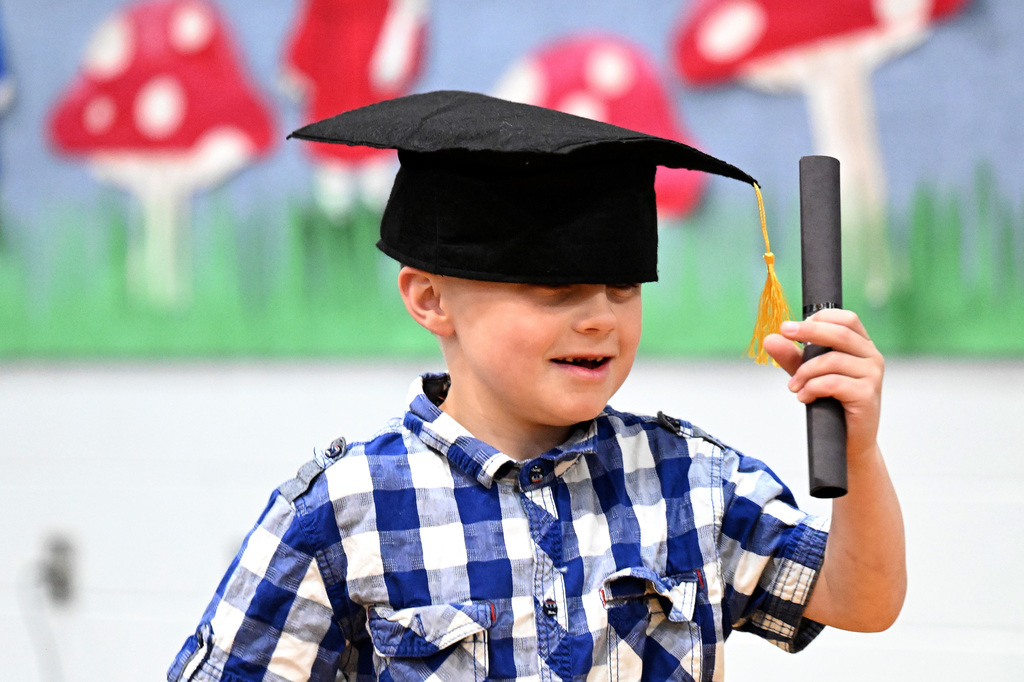 a young boy walking at graduation