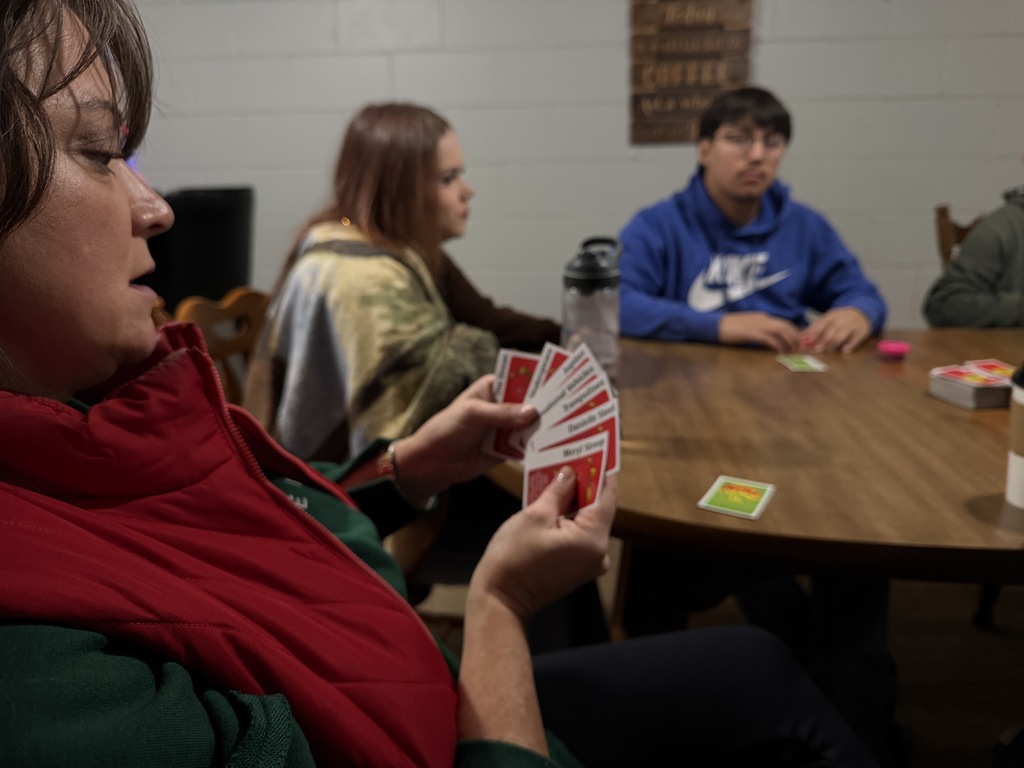 someone playing cards with others