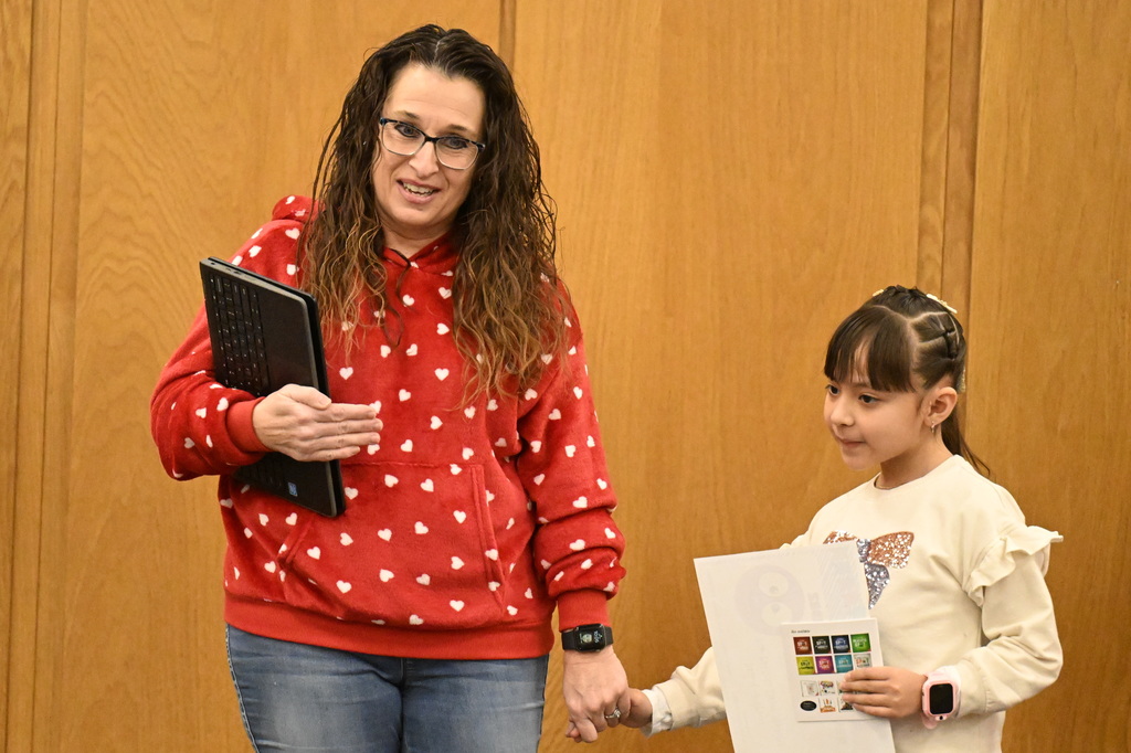 a teacher holding a student's hand