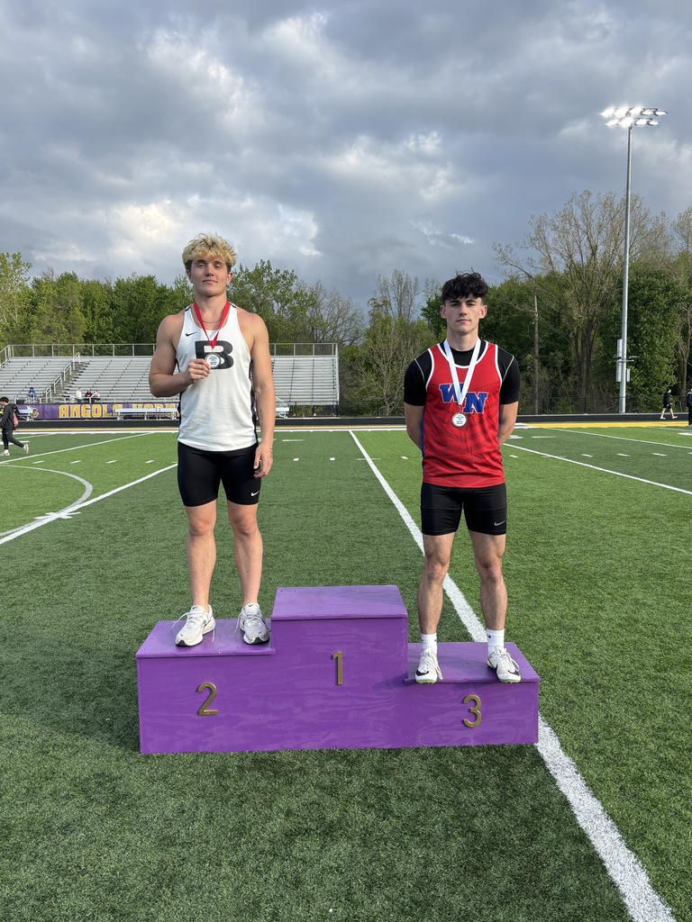 two boys on a podium at a track meet