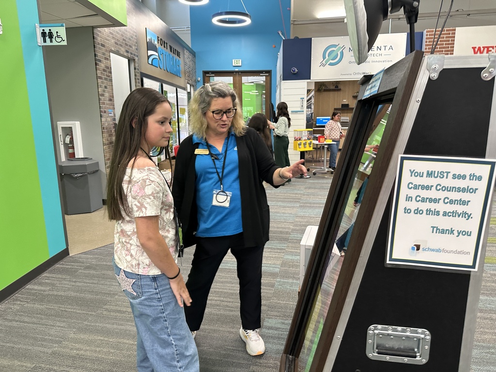 a women and girl talking about a work item at JA BizTown