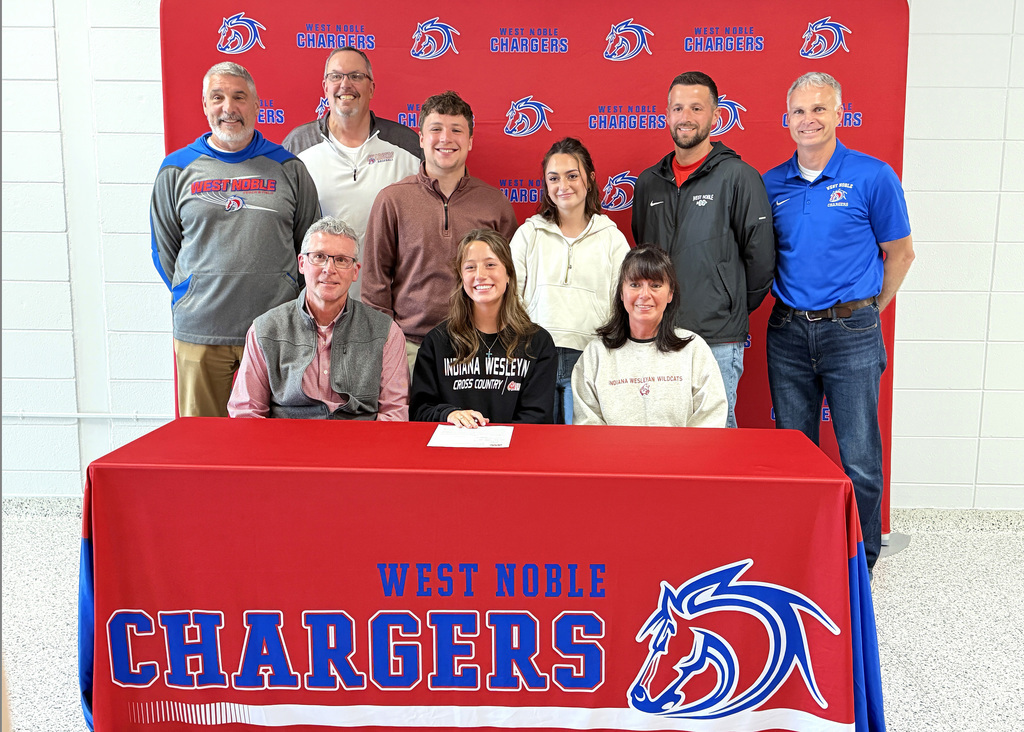trinity parson with family and friends at a signing event at the high school
