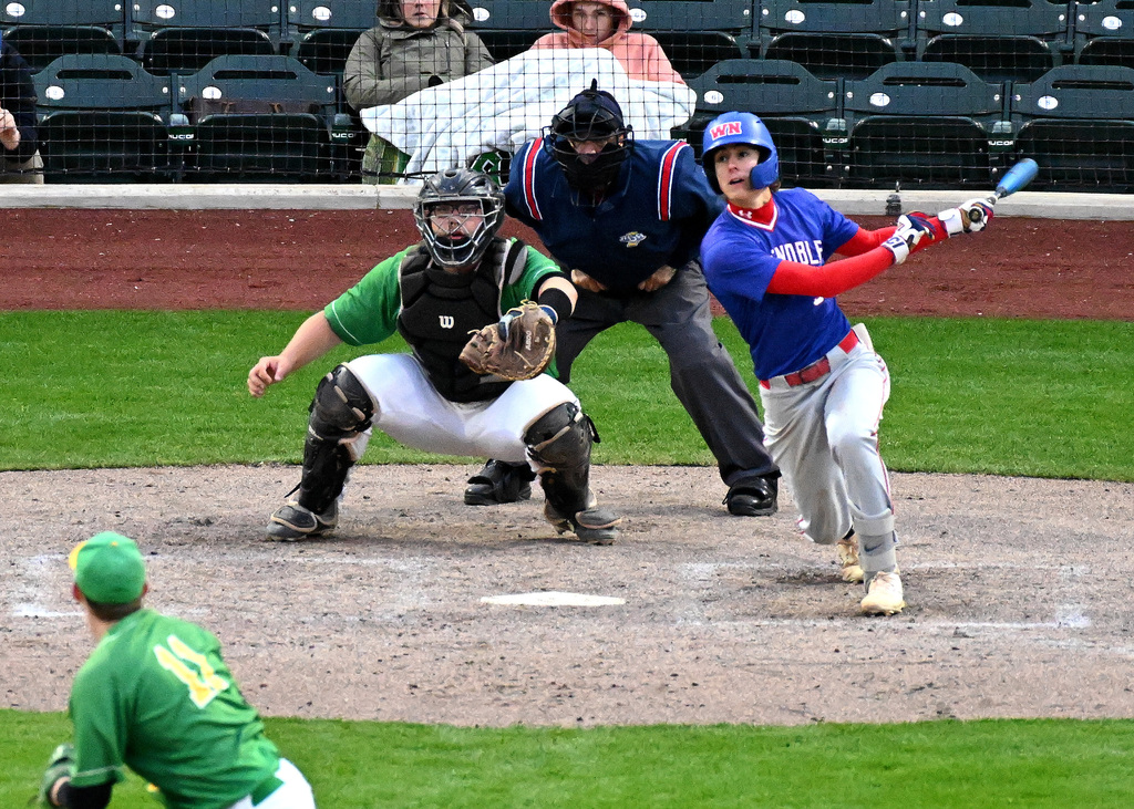 baseball player watching the ball play after hitting it