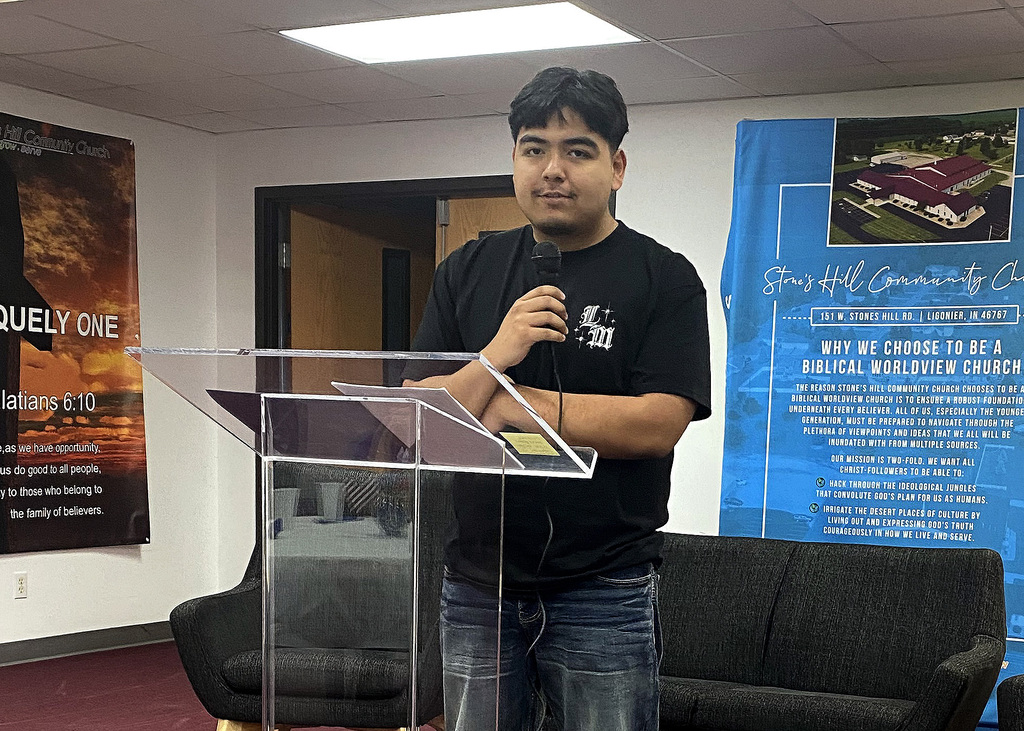 student reading a story at a podium