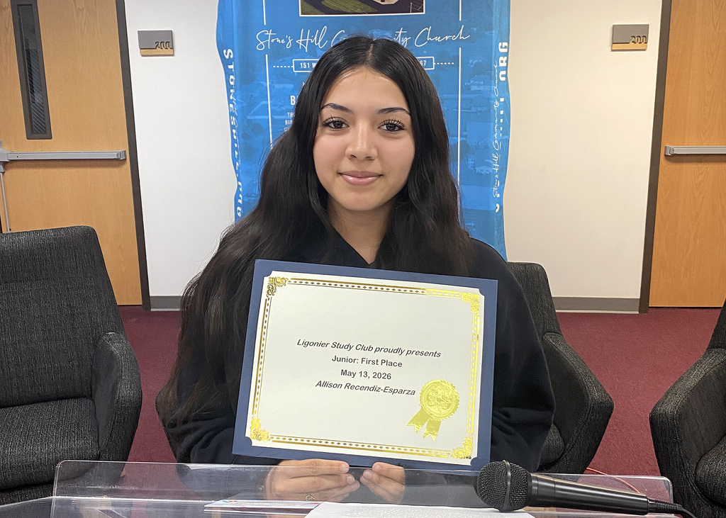 student holding a certificate