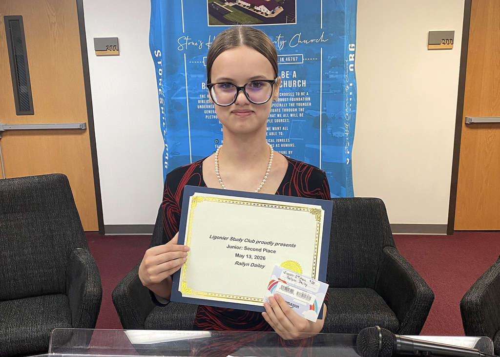 student holding a certificate